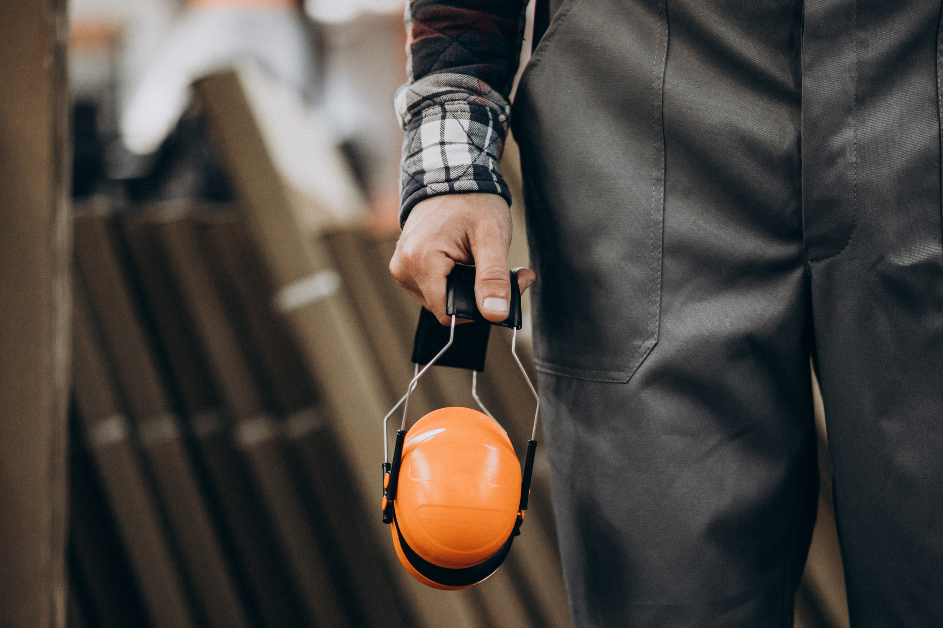young-male-handyman-with-safety-earphones