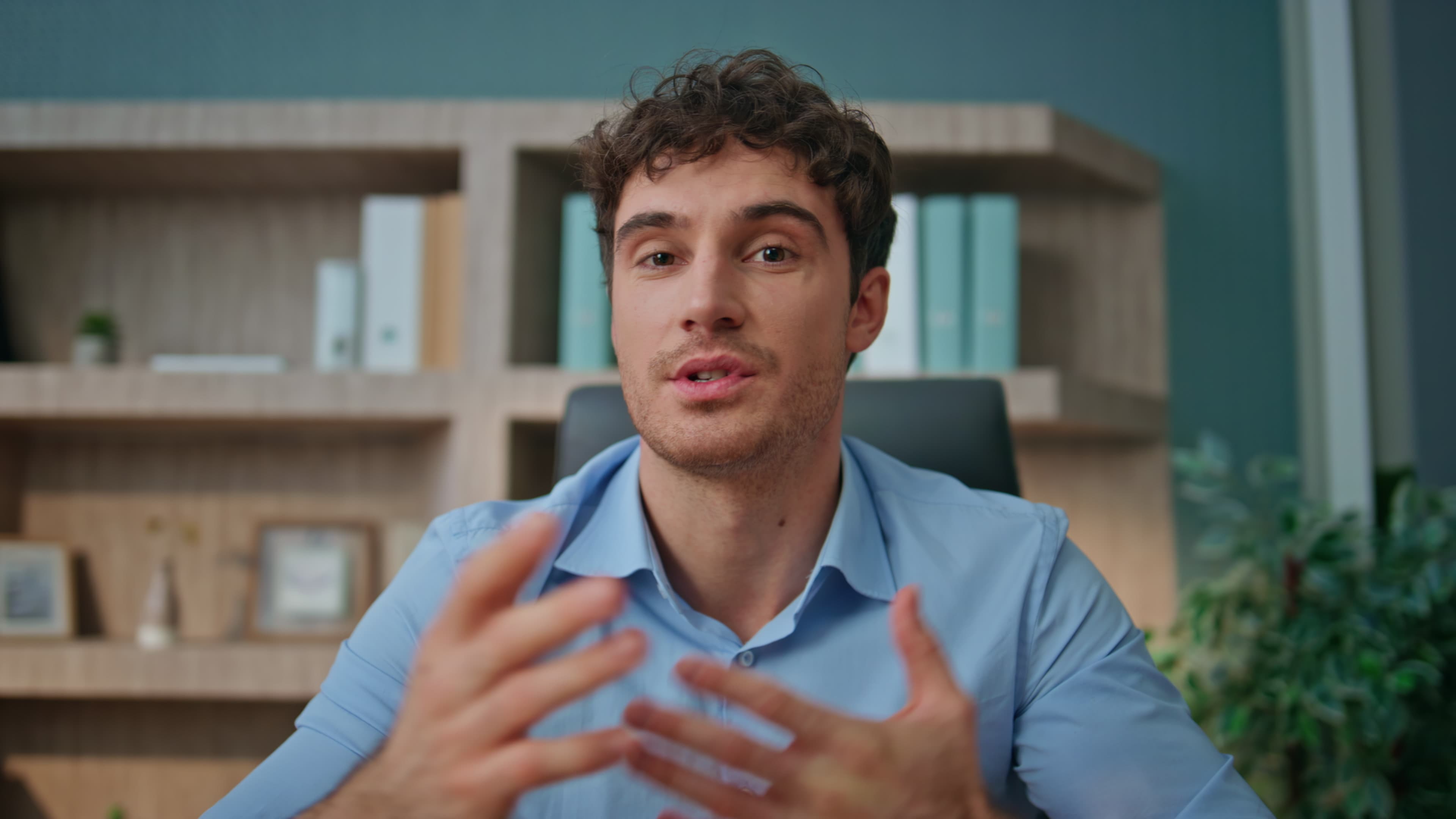 pov-entrepreneur-talking-camera-interview-office-online-coach-waving-hand_1