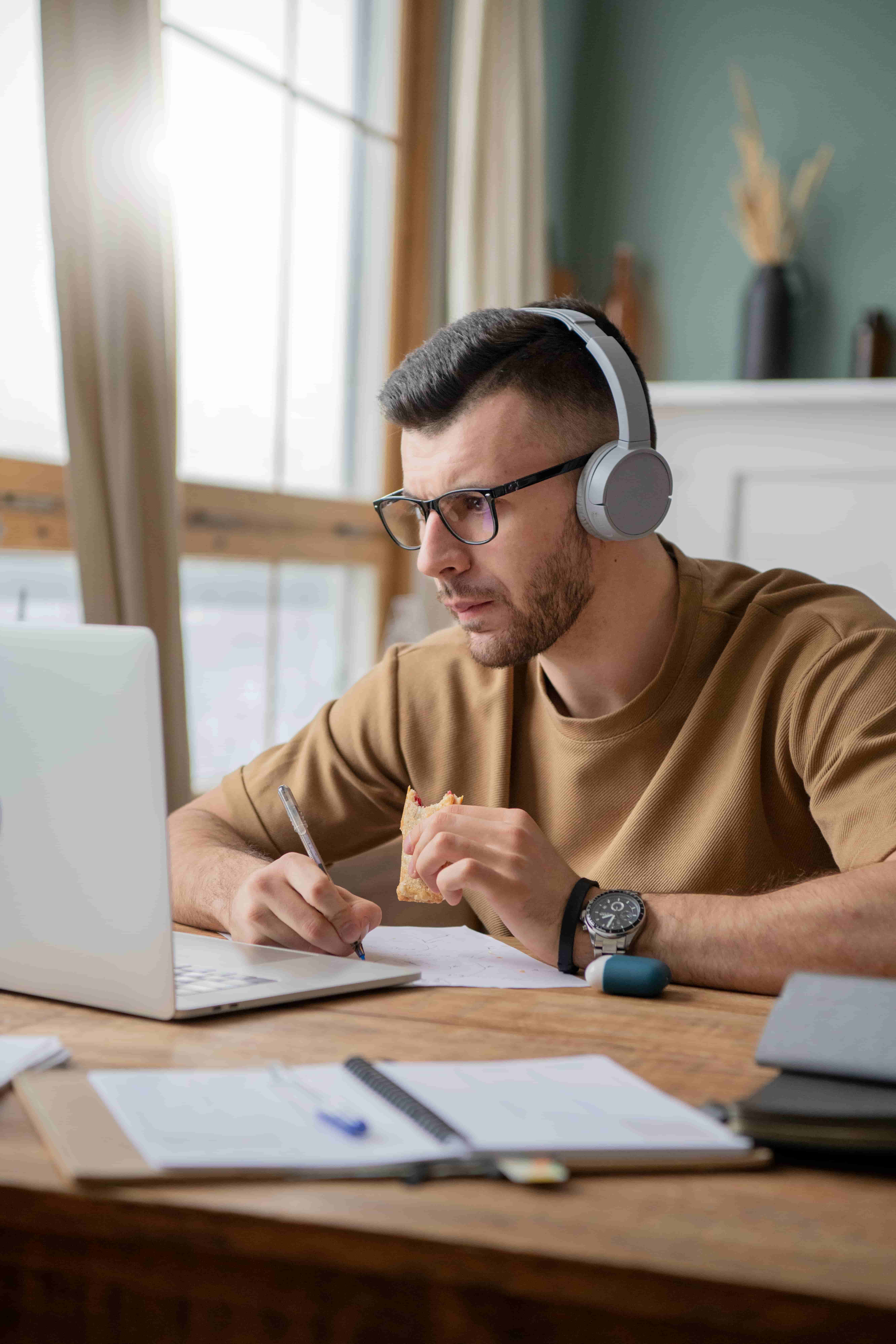 young-man-studying-library-using-laptop_1_1
