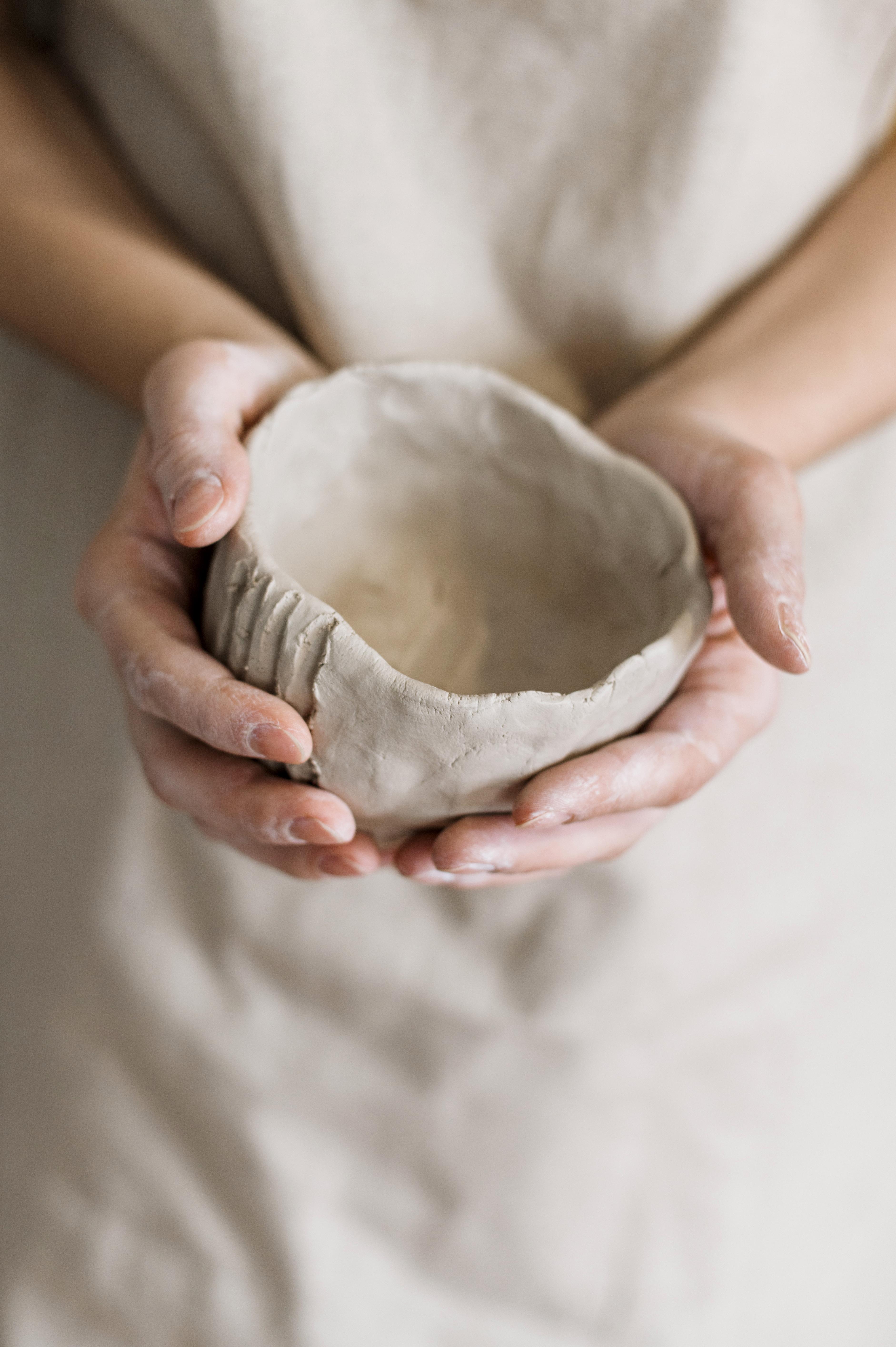 woman-holding-pottery-pieces-made-by-herself