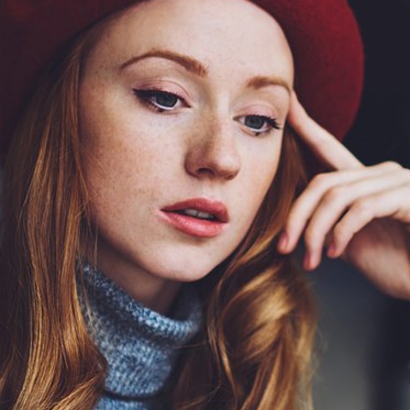 calm-female-freelancer-using-phone-and-looking-at-2023-11-27-05-30-17-utc