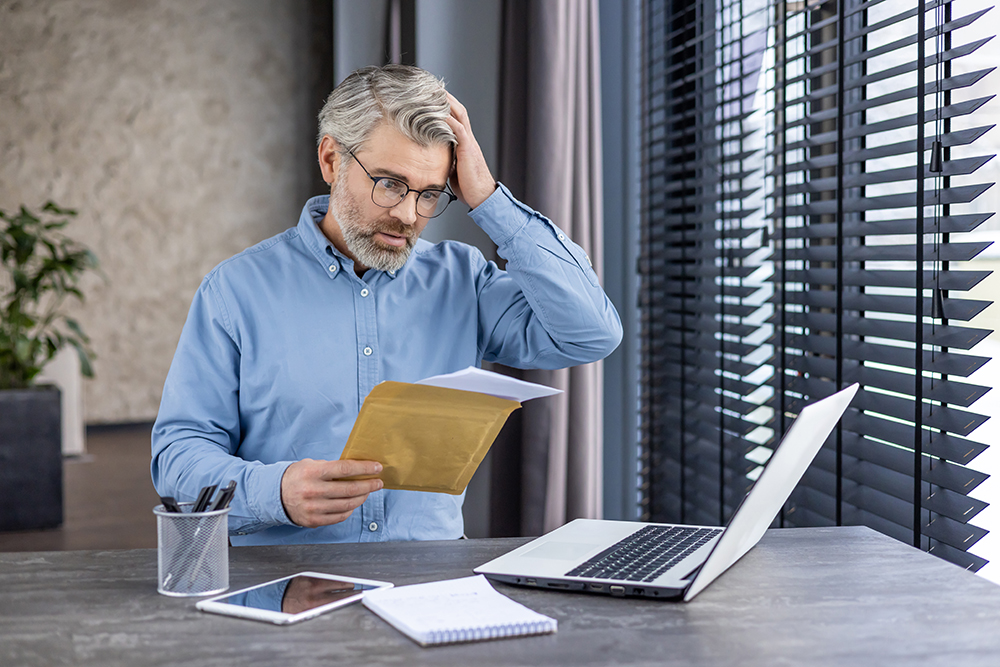 sad-unhappy-man-sitting-at-workplace-inside-office-2025-03-24-10-57-13-utc