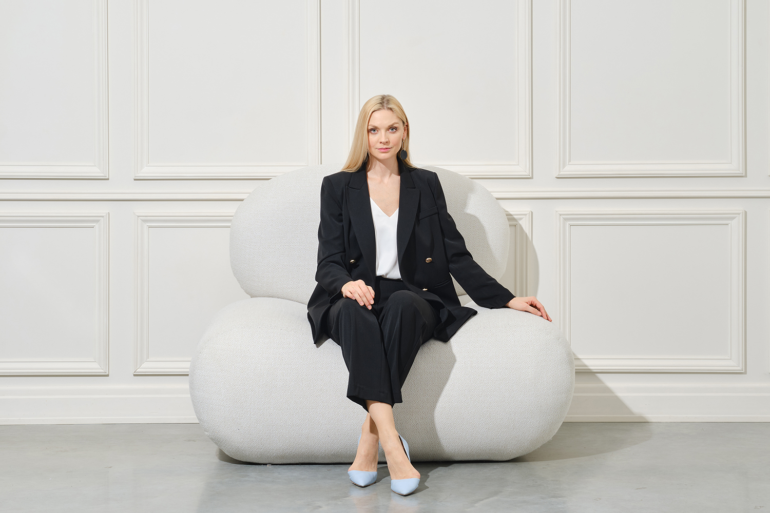 confident-businesswoman-in-pantsuit-sits-on-bean-b-2024-11-04-20-21-54-utc