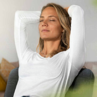 woman-relaxing-on-chair-at-home-SBOF03430