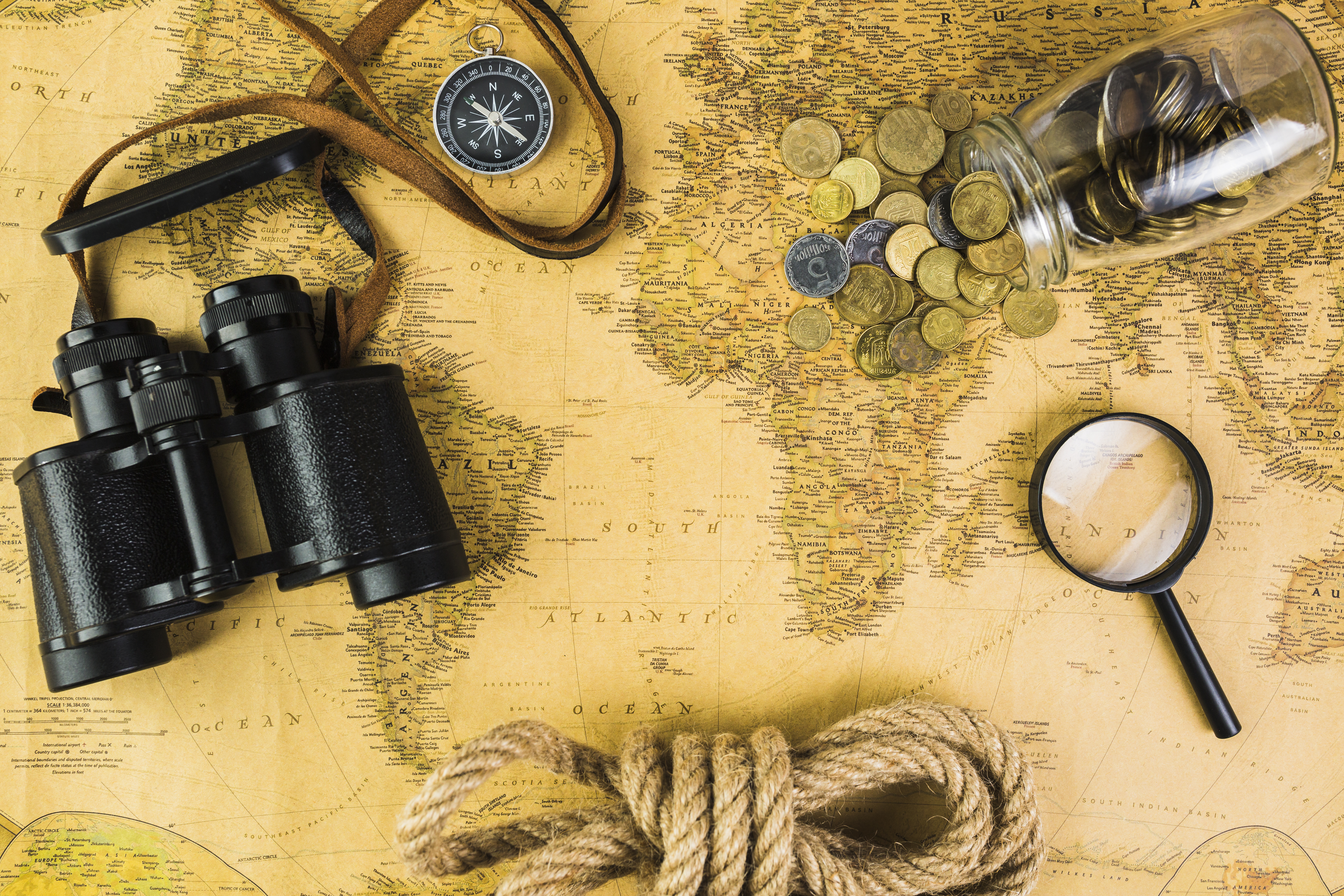 travelling-equipments-glass-jar-with-coins-vintage-map