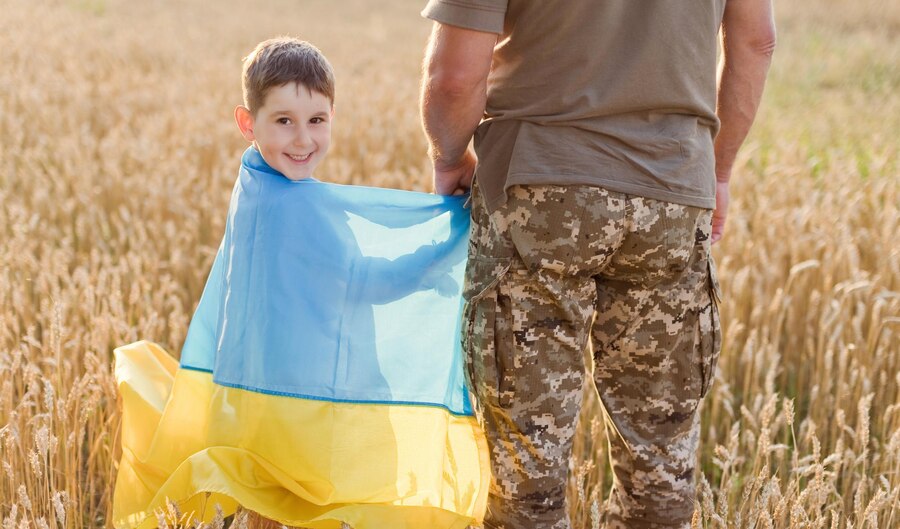 military-man-child-with-ukraine-flag_255880-2509